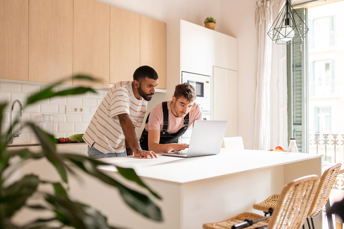 Gay couple using laptop