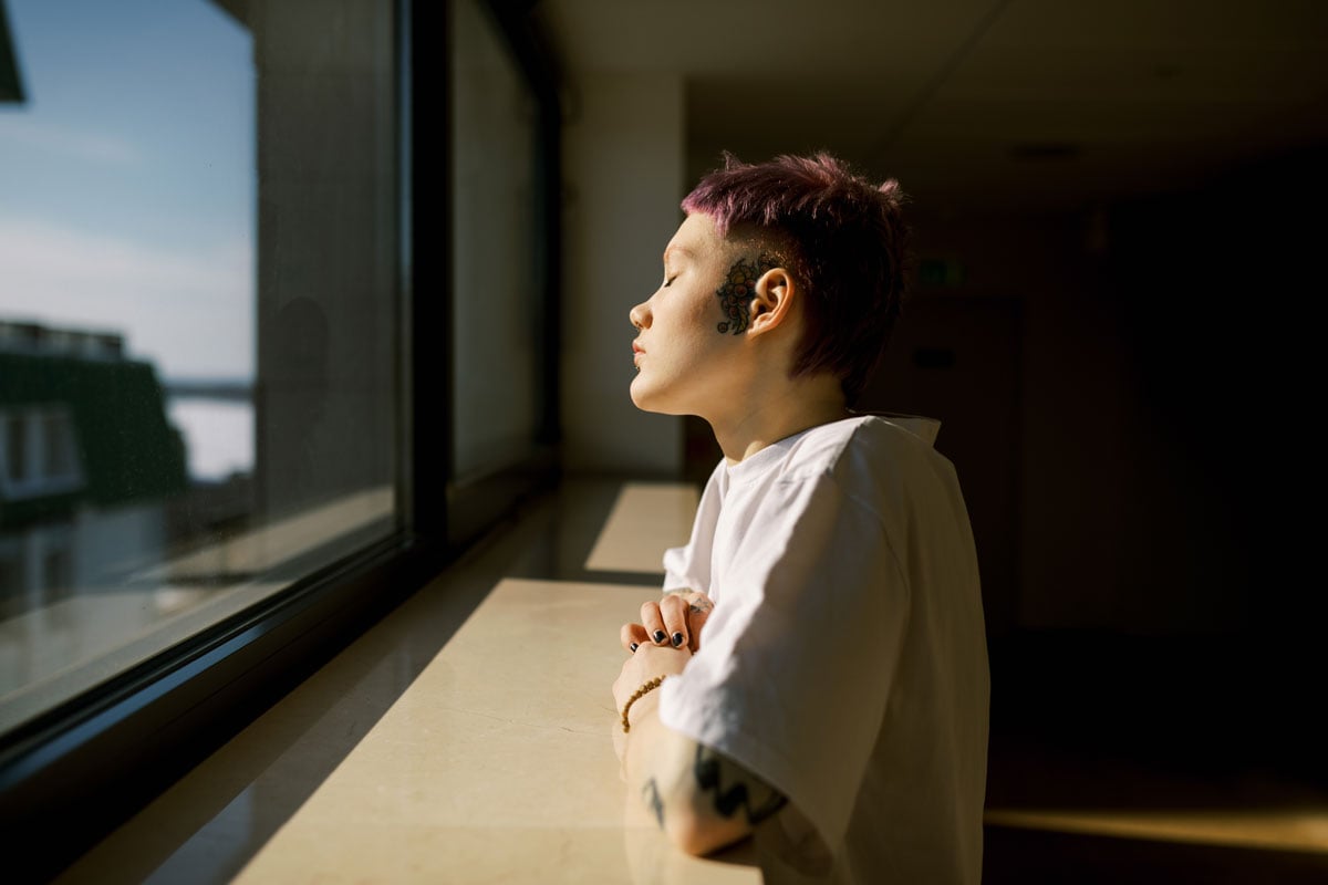 Portrait Of Young Androgyne Woman With Short Violet Color Hair
