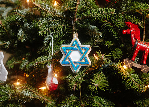 Closeup of Christmas tree with Hanukkah ornament