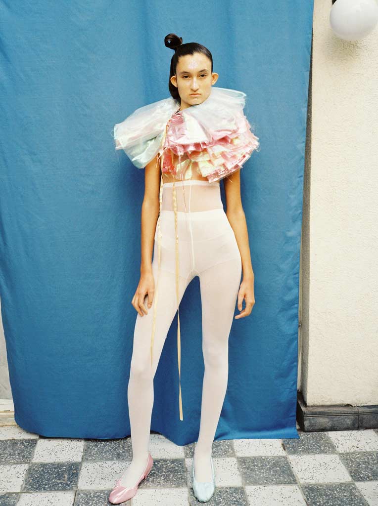 Portrait of a model wearing an Elizabethan style ruffle collar in pastel coloured fabric.