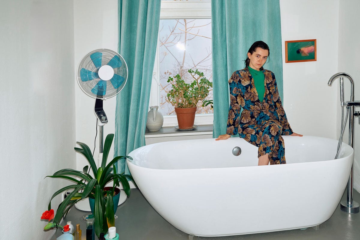 Photos of a woman sitting elegantly in a bathtub